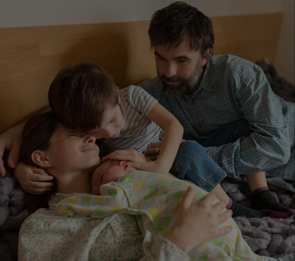 Parents cuddling their toddler